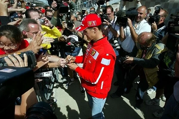 Formula One World Championship: Championship leader Michael Schumacher Ferrari is the centre of attention for both fans and media