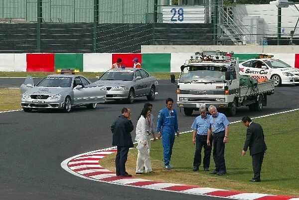 Formula One World Championship: Charlie Whiting and Herbie Blash inspect the new chicane with the circuit organisers