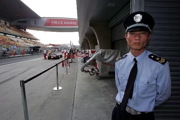 Formula One World Championship: Chinese police man in the pitlane