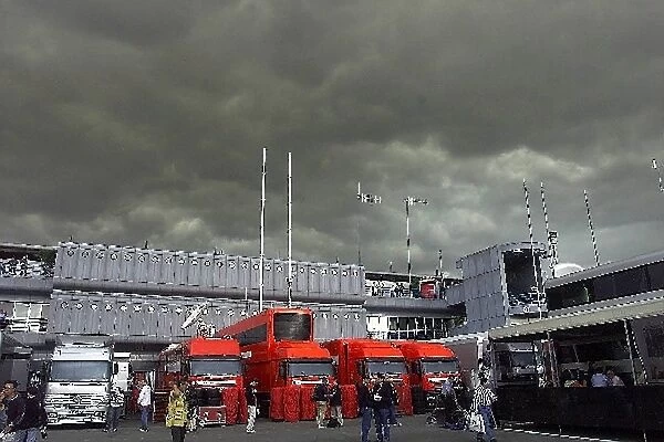 Formula One World Championship: The clouds roll in over Monza. Note Ferrari unbranded trucks