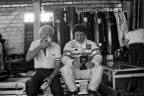Formula One World Championship: Colin Chapman Lotus Team Owner in the pit garage with Mario Andretti Lotus, who spun out of the race on lap 2