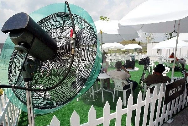 Formula One World Championship: Cooling fans in the rest area make an ideal venue for the ITV studio team