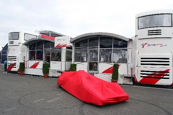 Formula One World Championship: A covered Toyota TF105 outside the Toyota motorhome
