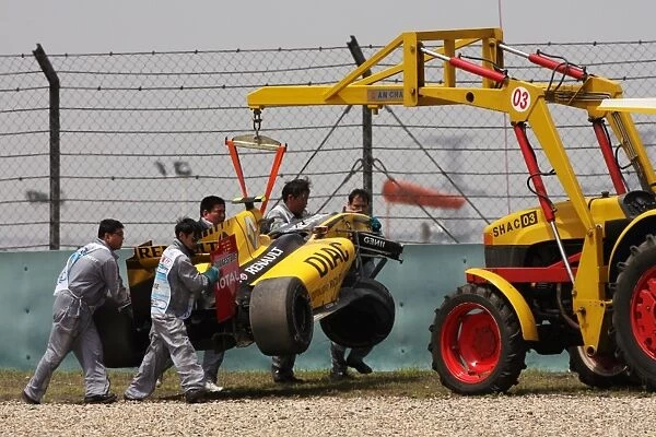 Formula One World Championship: The crashed Renault R30 of Vitaly Petrov Renault is craned away in the third practice session