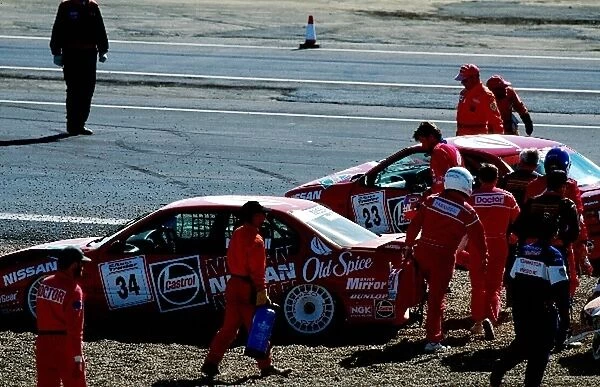 Formula One World Championship: The damaged Nissan Primera eGT of Keith O├òdor and the Nissan Primera eGT of Tiff Needell sit in the gravel trap