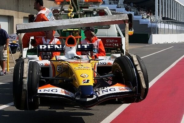 Formula One World Championship: The damaged Renault R27 of Heikki Kovalainen Renault is returned to the pits