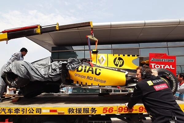 Formula One World Championship: The damgaged Renault R30 of Vitaly Petrov Renault is returned to the pits on a truck