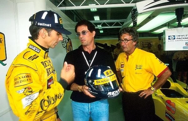 Formula One World Championship: Damon Hill, Jordan 198, chats with Team Boss Eddie Jordan and Film Star Sly Stallone
