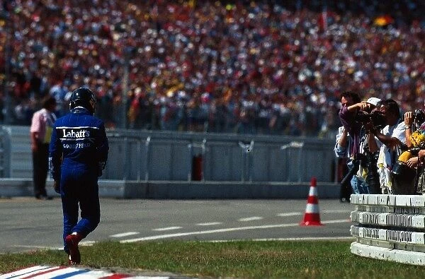 Formula One World Championship: Damon Hill Williams returns unhappily to the pits after losing out on his first GP victory due to a puncture