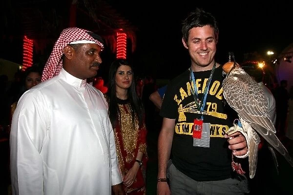 Formula One World Championship: Daniel Kalisz with a Falconer at the Bahrain GP welcome party