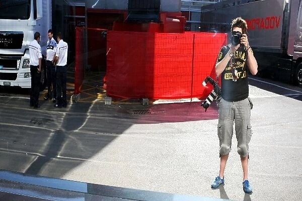 Formula One World Championship: Daniel Kalisz Sutton Motorsport Images Photographer shoots himself outside the McLaren motorhome