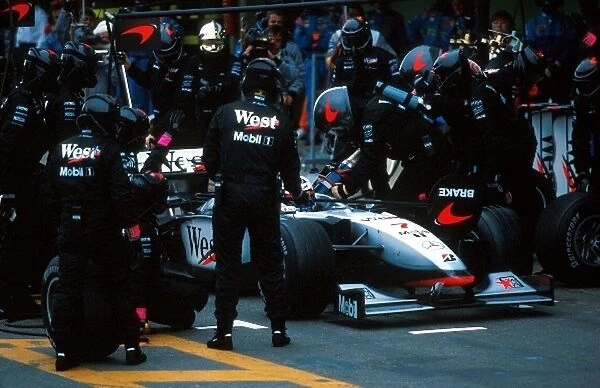 Formula One World Championship: David Coulthard McLaren Mercedes MP4  /  13 makes a pitstop on his way to 2nd place