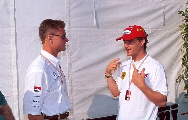 Formula One World Championship: David Coulthard Mclaren MP4-11 and Eddie Irvine Ferrari F310, right