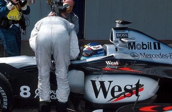 Formula One World Championship: David Coulthard McLaren who finished 2nd, chats to race winner Mika Hakkinen McLaren Mercedes MP4  /  13 in parc ferme