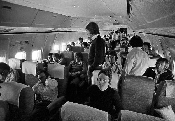 Formula One World Championship: Drivers and team personnel on board a flight to Sao Paulo, including Patrick Depailler Tyrrell, Ronnie Peterson Lotus