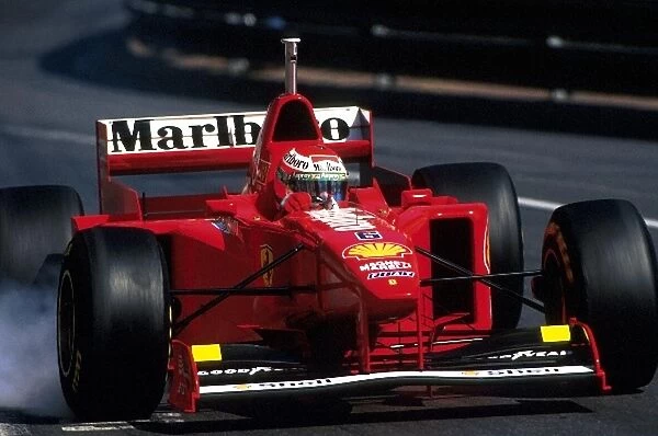 Formula One World Championship: Eddie Irvine, Ferrari F310B 3rd place locks a wheel in practice