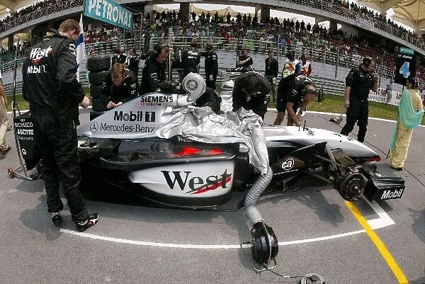 Formula One World Championship: Efforts to keep the Mclaren MP4  /  17 of Kimi Raikkonen cool on the grid proved futile during the race