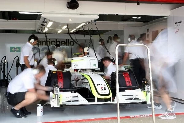 Formula One World Championship: Engineers at work around the car of Rubens Barrichello Brawn Grand Prix BGP 001