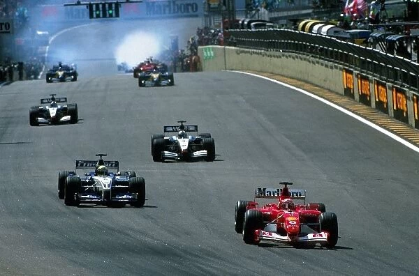 Formula One World Championship: Eventual race winner Michael Schumacher Ferrari F2002 leads his brother Ralf Schumacher BMW Williams FW24 away