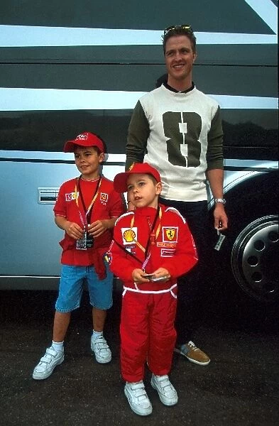 Formula One World Championship F: Ralf Schumacher poses with some of his Brothers fans