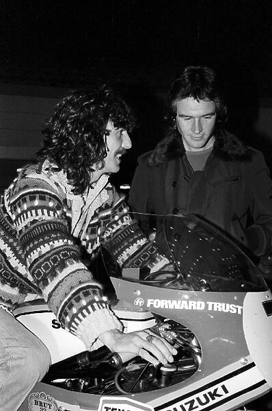 Formula One World Championship: F1 celebrity fan George Harrision Beatles guitarist tries out the Suzuki motorbike of Barry Sheene who was competing