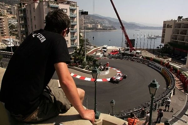 Formula One World Championship: A fan watches Fernando Alonso McLaren Mercedes MP4  /  22