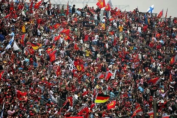 Formula One World Championship: Fans celebrate as Michael Schumacher Ferrari leads the race