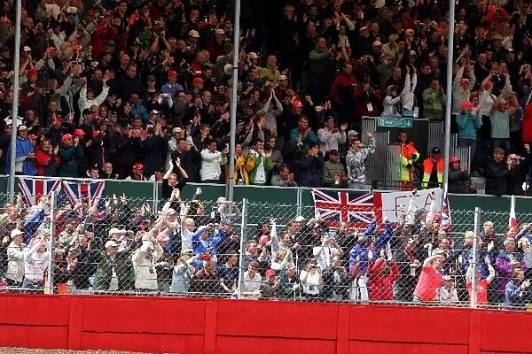 Formula One World Championship: The fans cheer race winner Lewis Hamilton McLaren at the end of the race