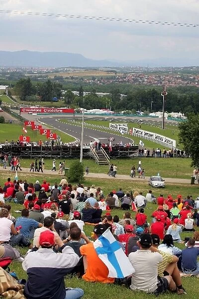 Formula One World Championship: Fans watch Michael Schumacher Ferrari during qualifying