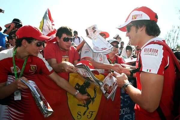Formula One World Championship: Fernando Alonso Ferrari signs autographs for the fans