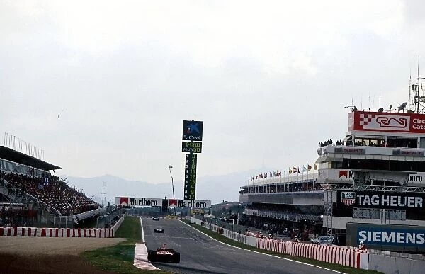 Formula One World Championship: A Ferrari F2001 exits the final corner and heads down the main straight