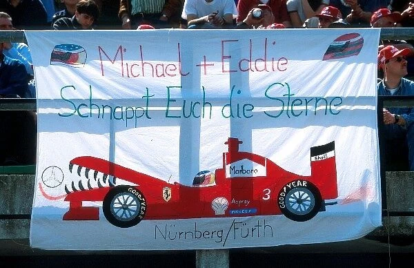 Formula One World Championship: A Ferrari fans banner depicting the Ferrari team devouring Mercedes