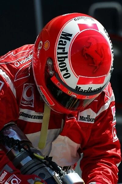 Formula One World Championship: Ferrari fuel man at pit stop practice
