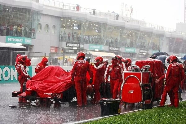 Formula One World Championship: Ferrari on the grid as the race is stopped