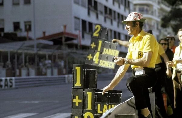 Formula One World Championship: A Ferrari mechanic holds out the pit board for Clay Regazzoni Ferrari, who led the opening laps before spinning on lap 21