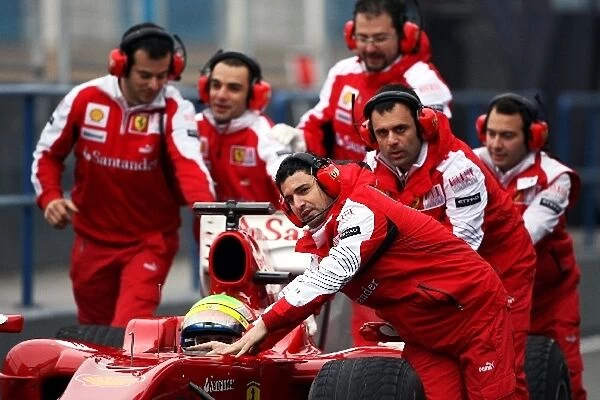 Formula One World Championship: Ferrari mechanics run to the aid of Felipe Massa Ferrari F10 as he stops at the pit lane entrance