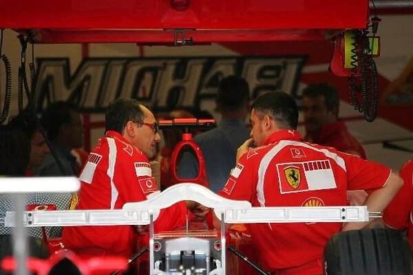 Formula One World Championship: Ferrari perform repairs on the Ferrari F248 F1 of Michael Schumacher Ferrari after qualifying
