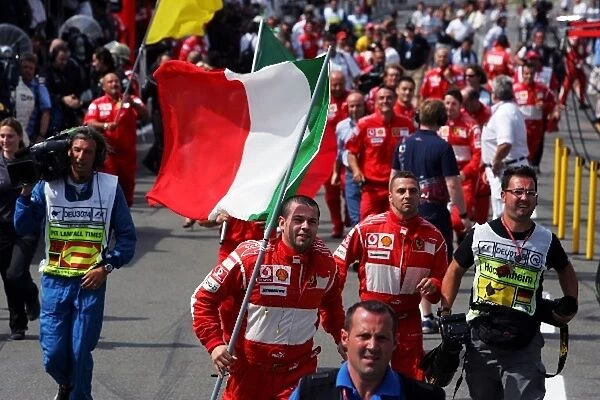 Formula One World Championship: Ferrari team run to parc ferme
