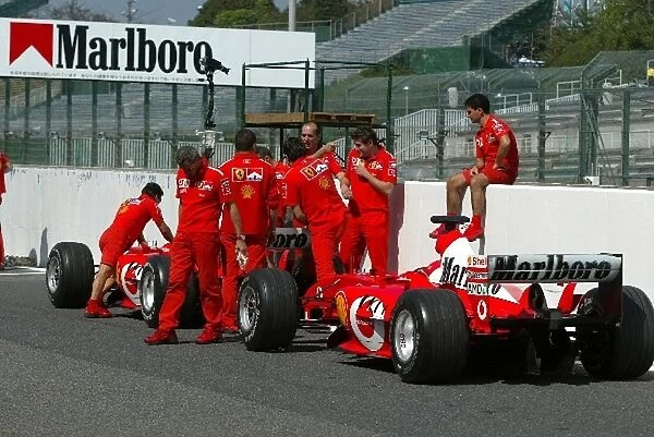 Formula One World Championship: The Ferrari team wait their turn for scrutineering