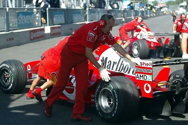 Formula One World Championship: The two Ferraris of Michael Schumacher Ferrari F2003-GA and Rubens Barrichello Ferrari F2003-GA are pushed