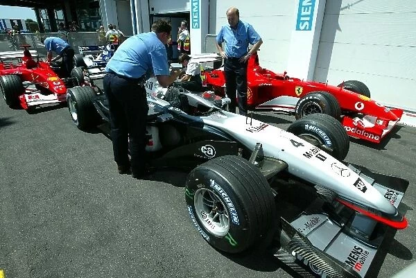 Formula One World Championship: The FIA inspect Kimi Raikkonens McLaren Mercedes MP4  /  17 in parc ferme post qualifying