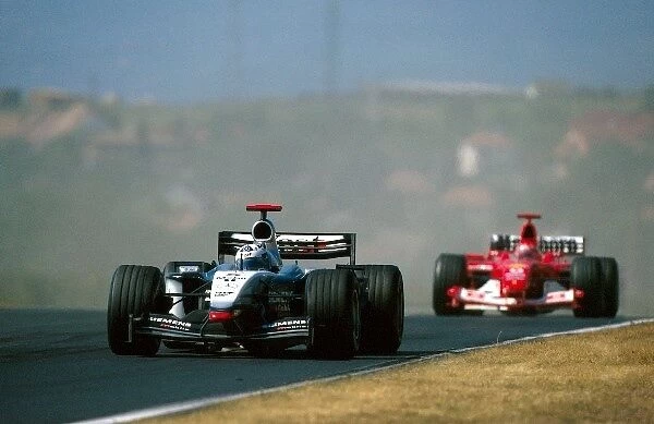 Formula One World Championship: Fifth placed David Coulthard McLaren Mercedes MP4 / 17D leads Michael Schumacher Ferrari F2003-GA, who finished eighth