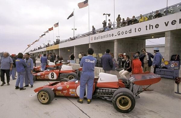 Formula One World Championship: Fifth placed Jacky Ickx sits on the pit wall beside his Ferrari 312B2 during practice