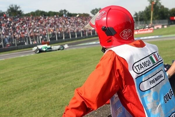 Formula One World Championship: A Fire Marshal watches Rubens Barrichello Honda RA108