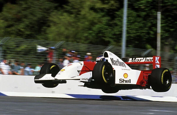 Formula One World Championship: The Flying Finn Mika Hakkinen launches his Mclaren MP4 / 8 into the air at the Malthouse Corner during a lap in