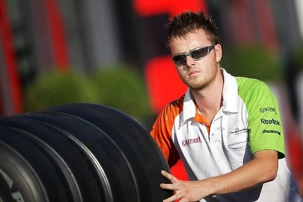 Formula One World Championship: Force India F1 mechanic with tyres