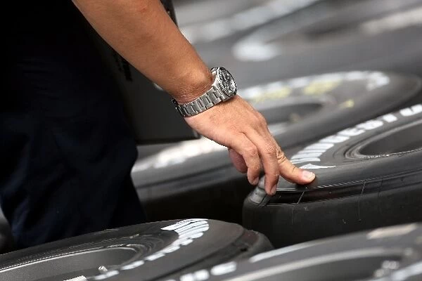 Formula One World Championship: Force India F1 wheels and tyres are checked by a Bridgestone engineer