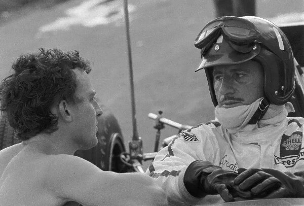 Formula One World Championship: Fourth place finisher Graham Hill Lotus 49B chats with Jackie Oliver Lotus