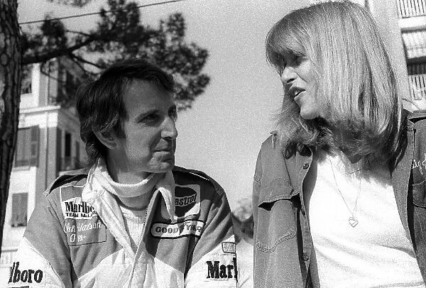 Formula One World Championship: Fourth placed John Watson McLaren talks with Jane Birbeck, girlfriend of James Hunt Wolf, whose F1 racing career