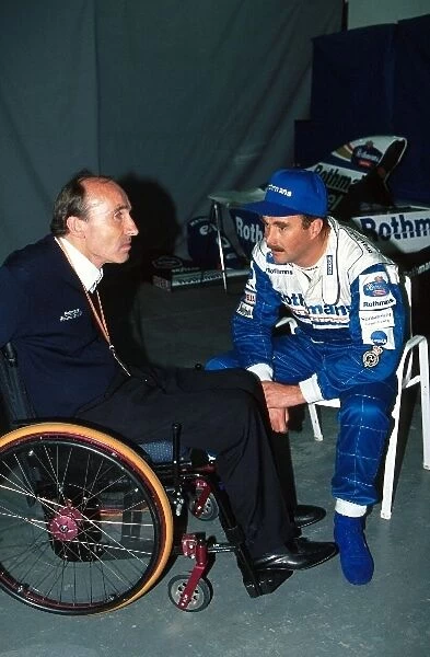 Formula One World Championship: Frank Williams Williams Team Boss talks with his 1994 part time driver Nigel Mansell, right